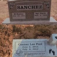 Two grey stone grave markers: one for Sanchez and one for Conner Lee Pool, set in a sandy cemetery.