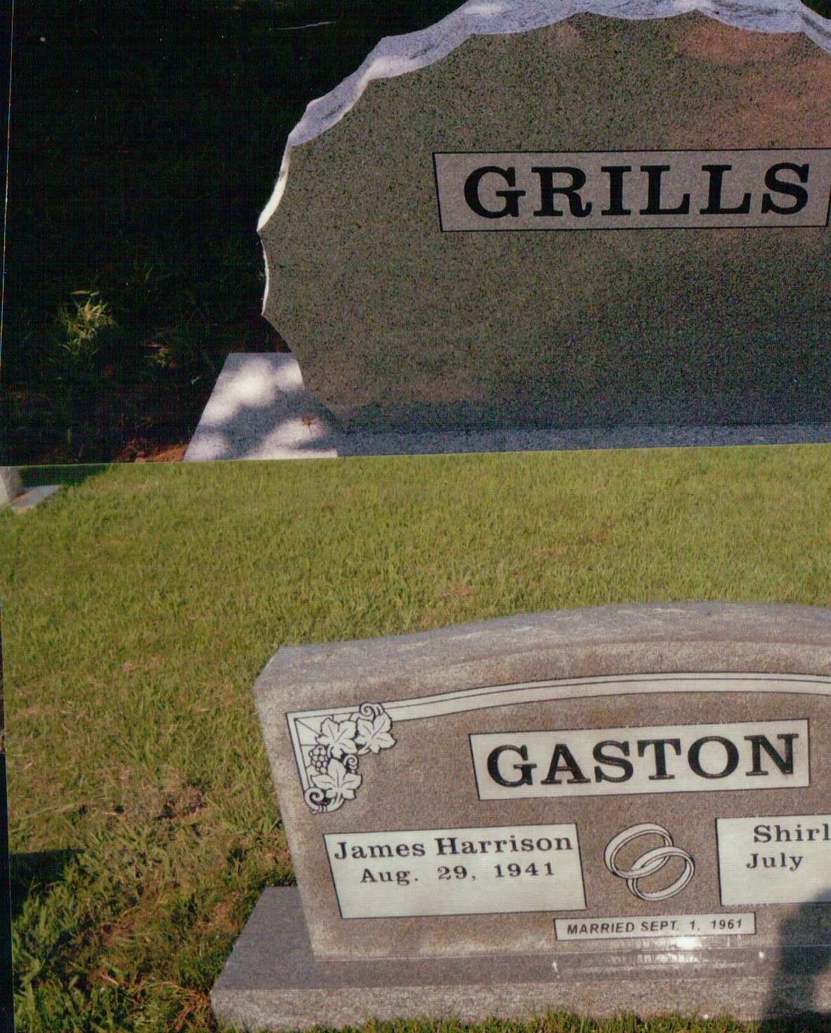 Two gravestones in a grassy cemetery, one marked 