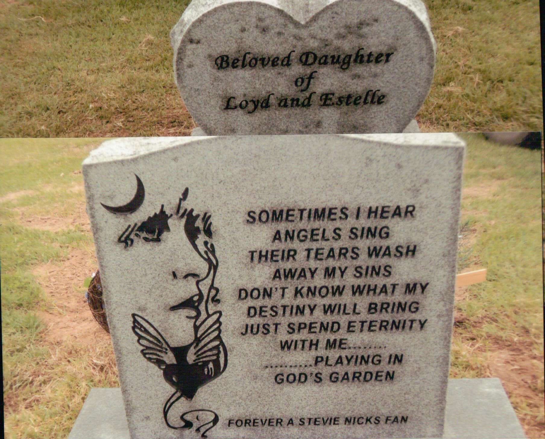 A heart-shaped tombstone atop a rectangular marker featuring a Stevie Nicks illustration and lyrics from 