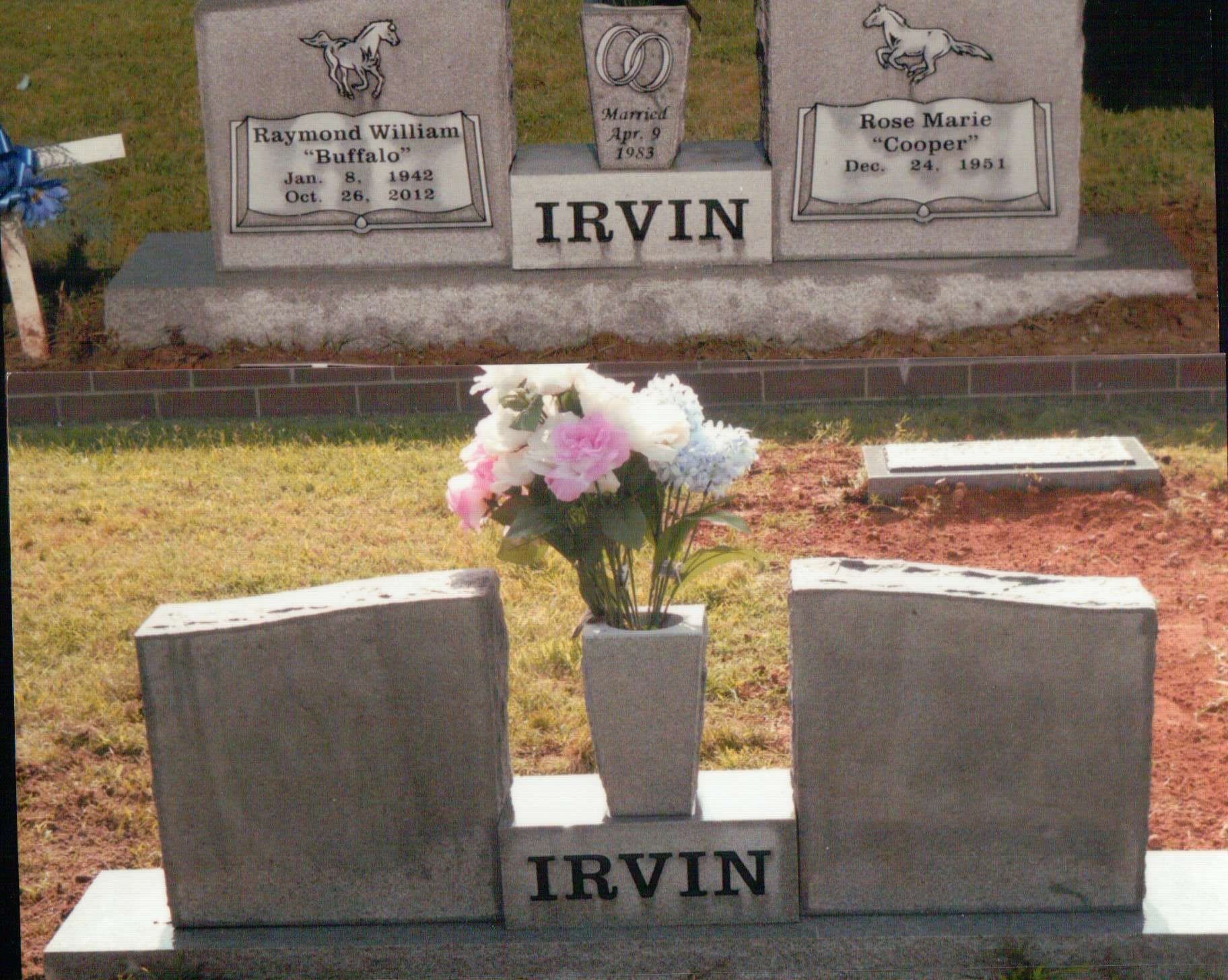 Two grey, upright granite IRVIN headstones in a cemetery, with a flower vase between them on the foreground marker.