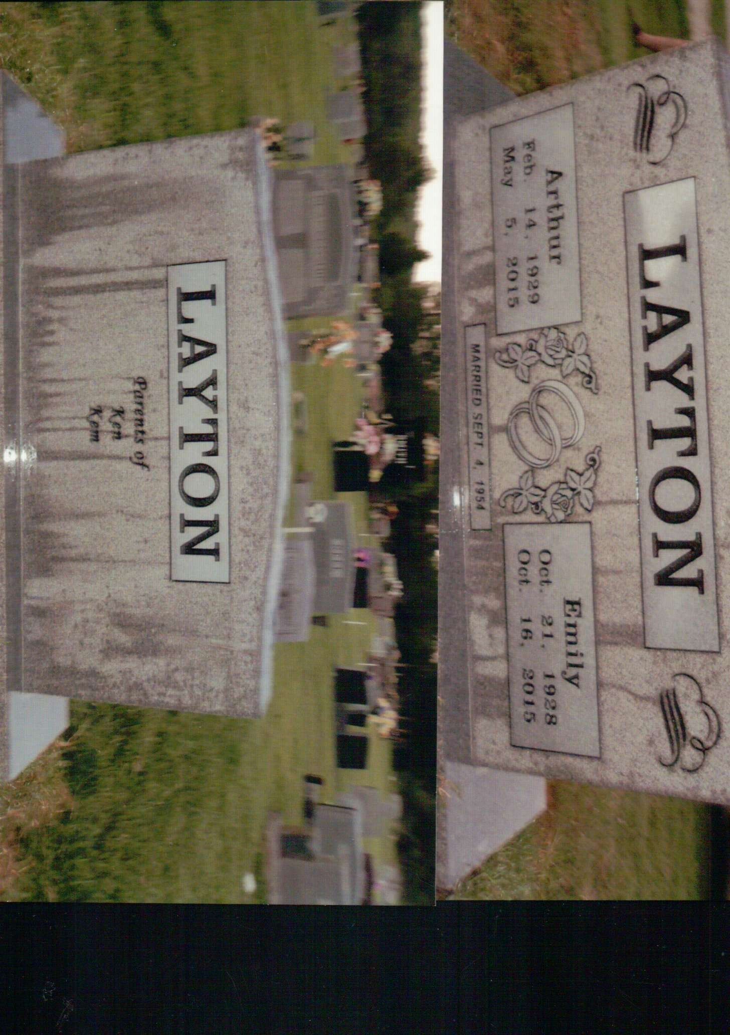 Two grave markers with the name LAYTON, featuring details for Arthur and Emily, in a cemetery setting.