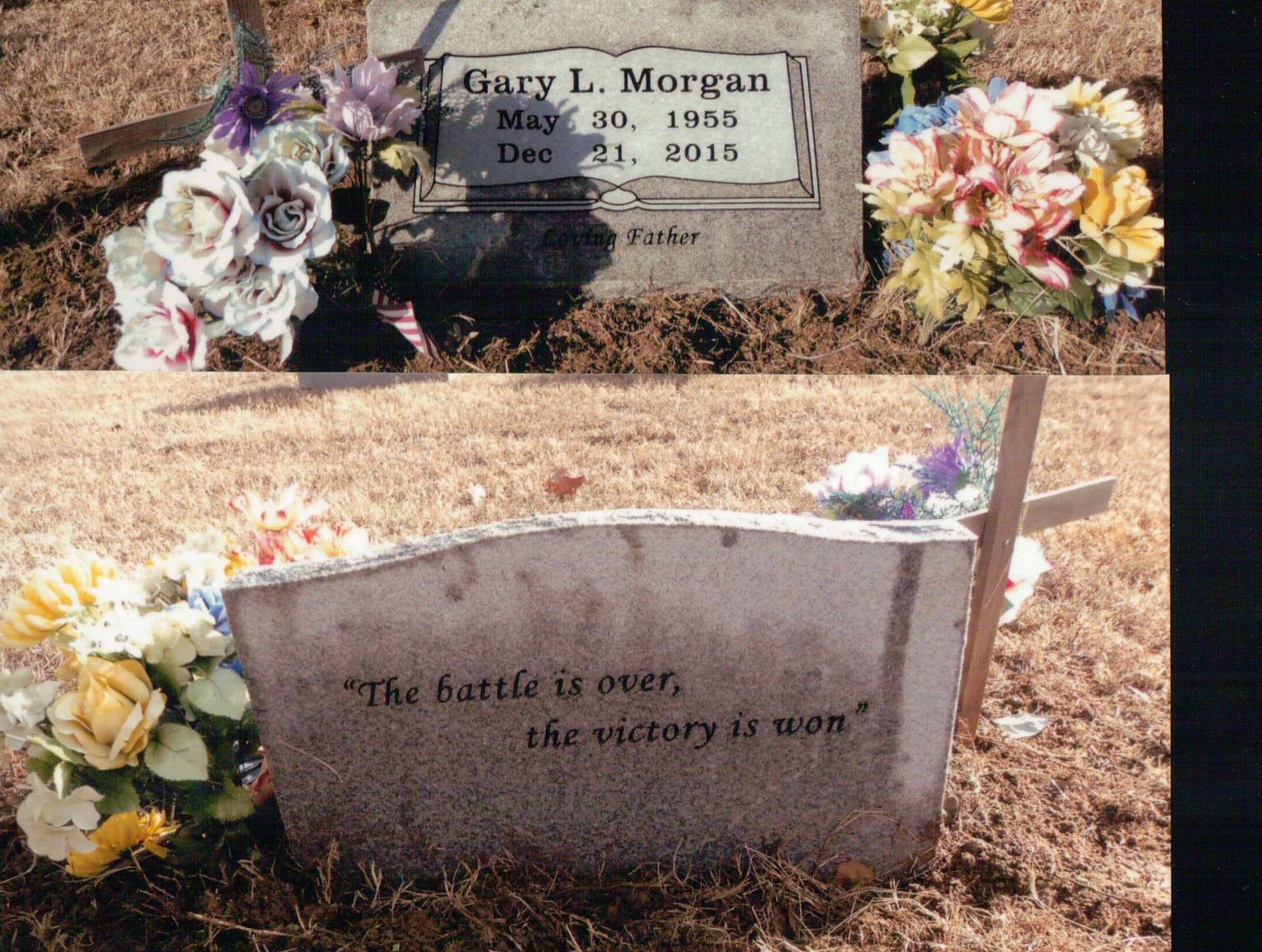 A grave marker for Gary L. Morgan, born 1955 and died 2015, with flowers and the inscription 