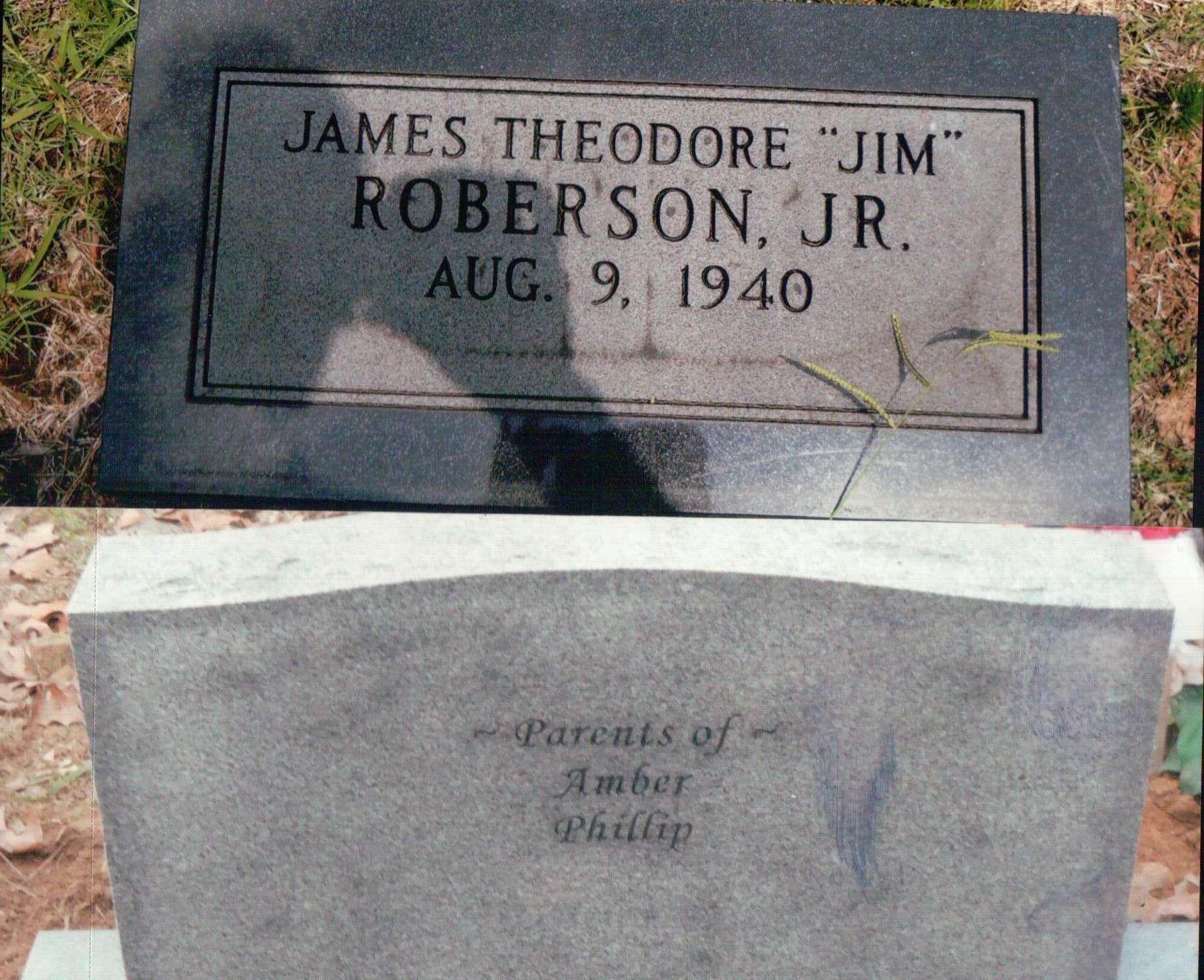 A dark granite gravestone inscribed 