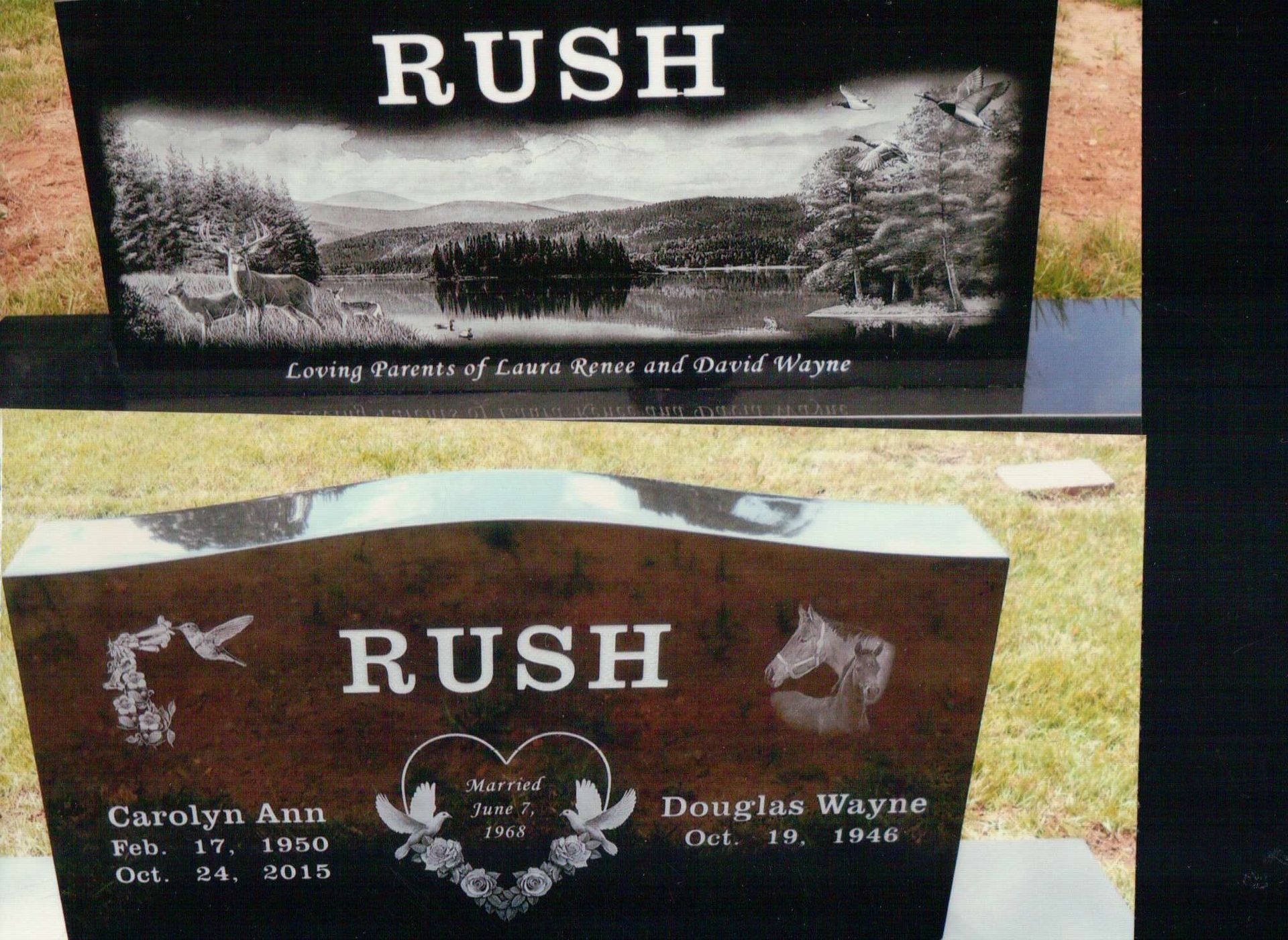 Two black granite Rush family grave markers, one with a scenic lake engraving and one with names and dates.