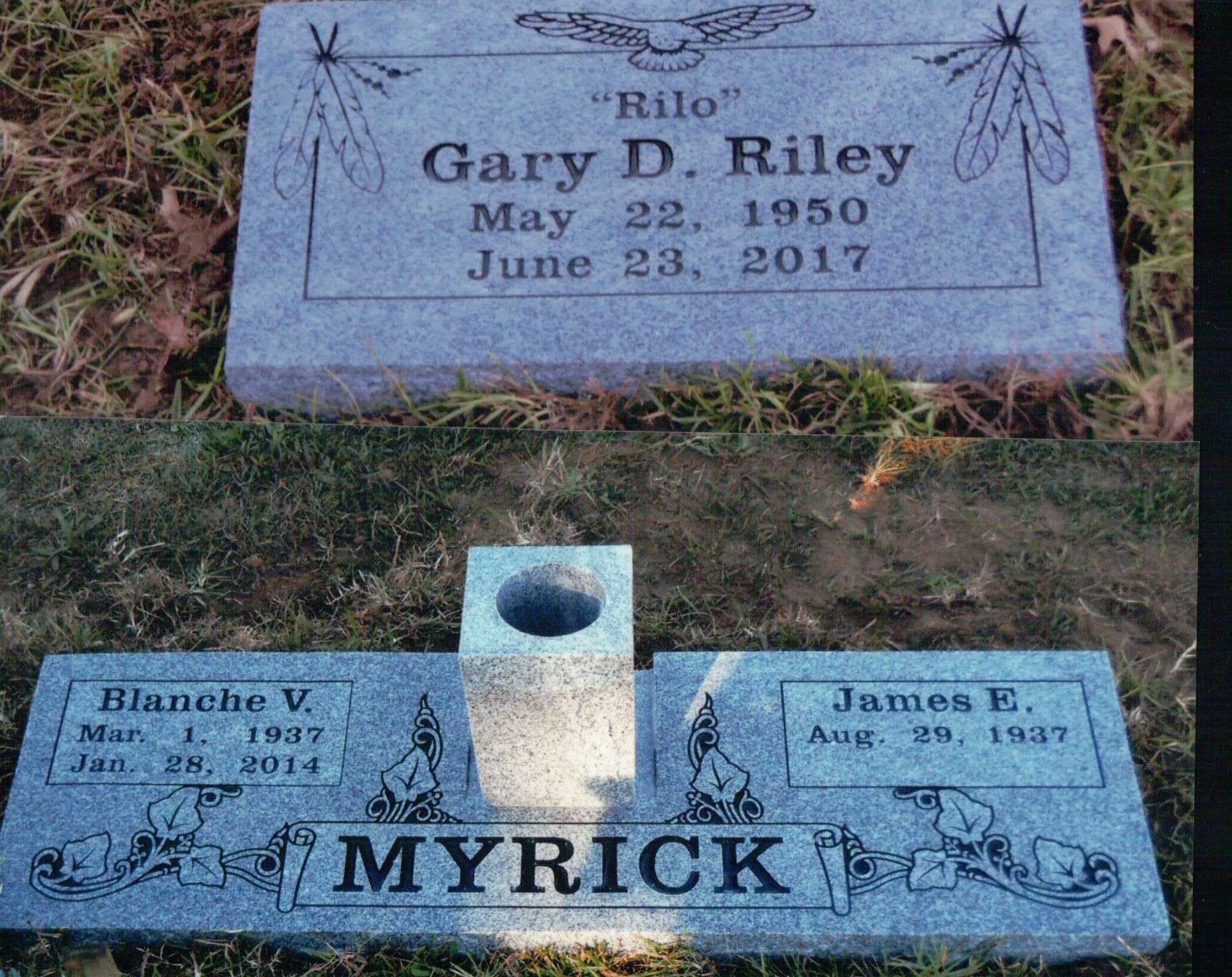 Two grey stone grave markers in grass; one reads Gary D. Riley, the other reads Myrick, for Blanche V. and James E.