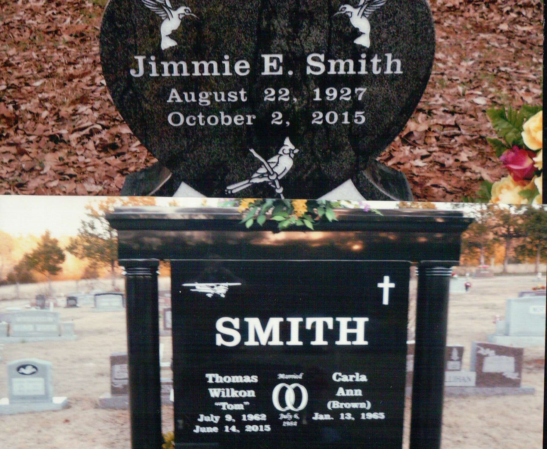 Two black granite grave markers in a cemetery. One is heart-shaped for Jimmie E. Smith; the other is a monument for Smith.
