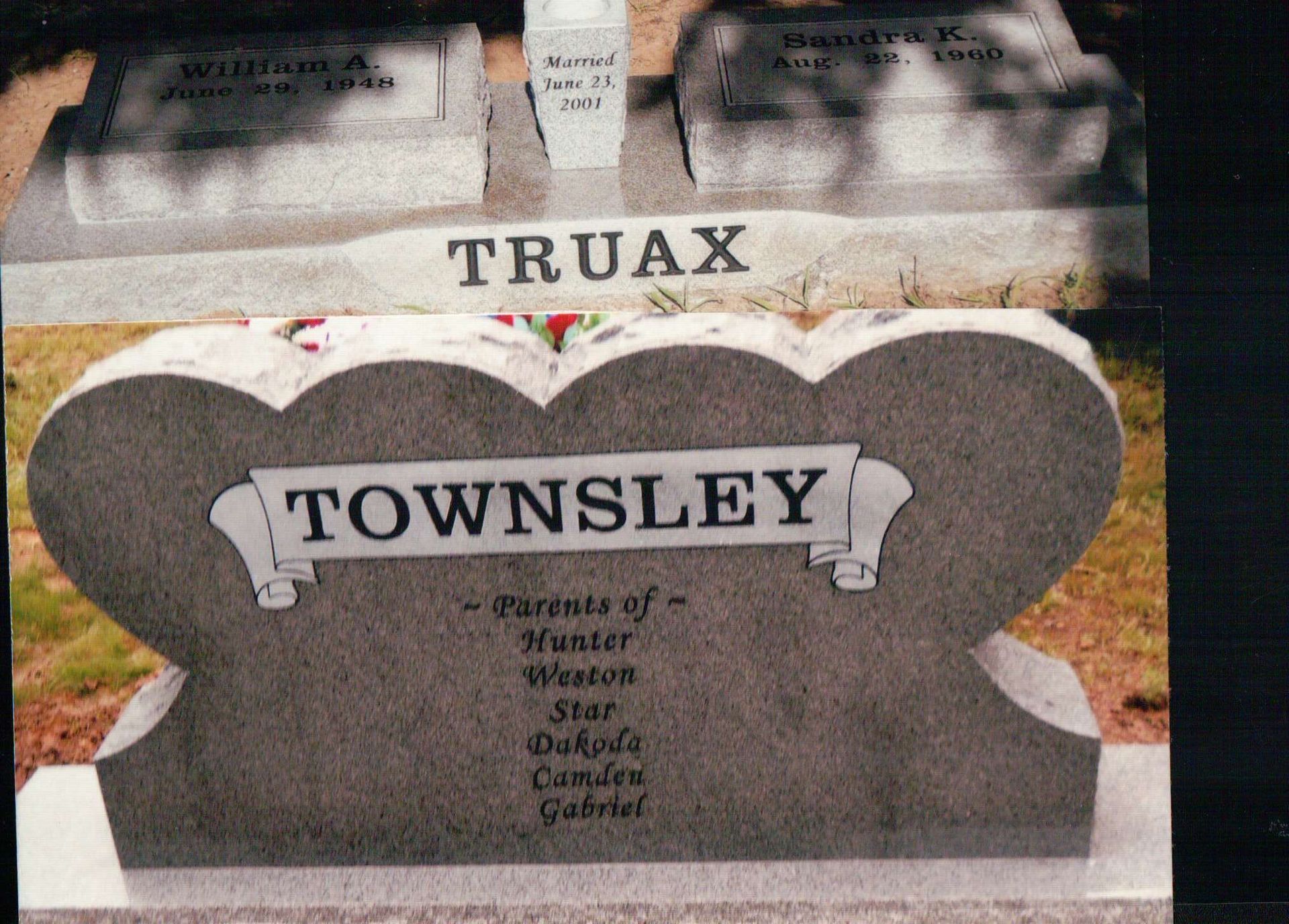 A gray stone monument with the names TRUAX and TOWNSLEY engraved, with a list of names below the TOWNSLEY inscription.