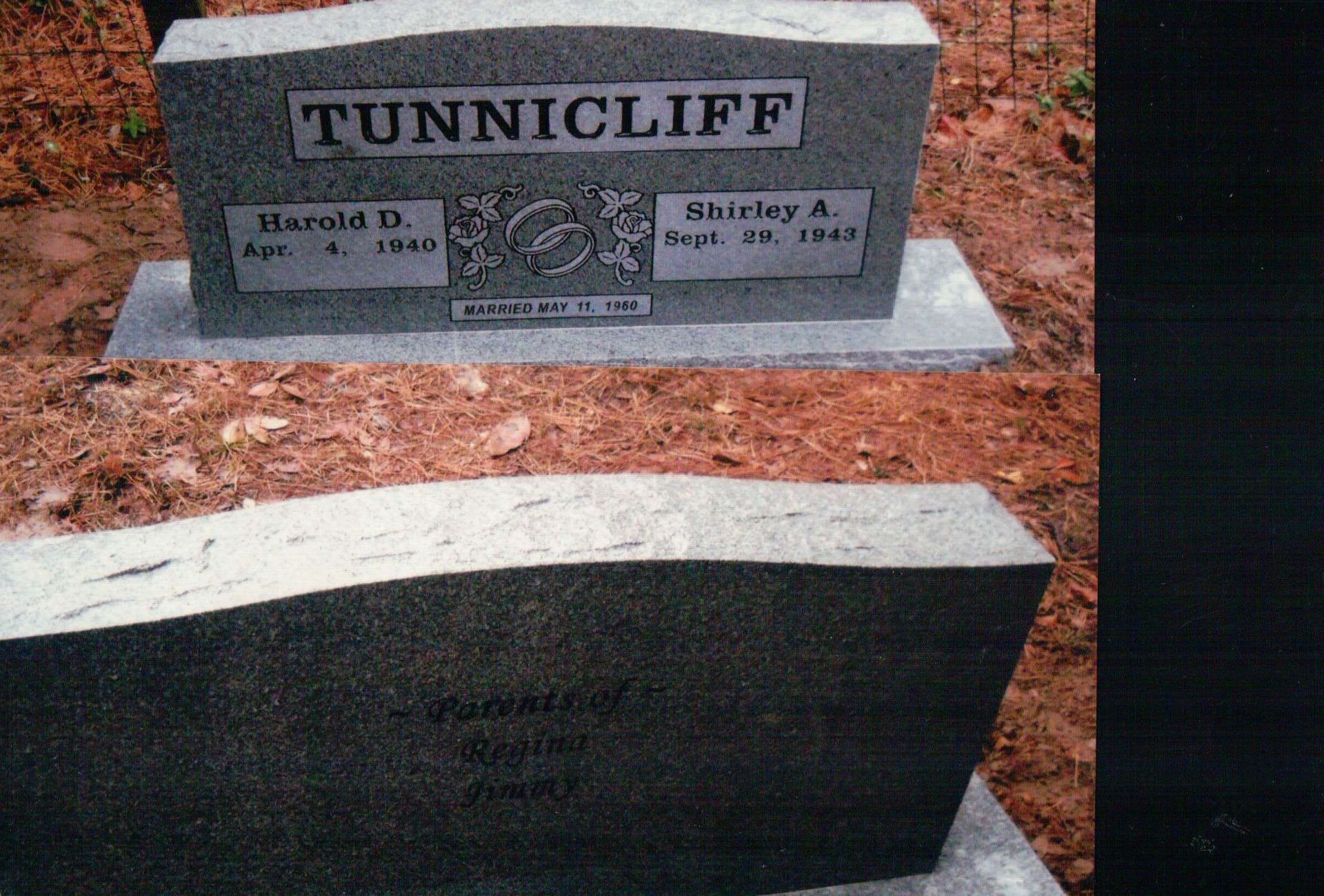 Two grey granite headstones, one marked 