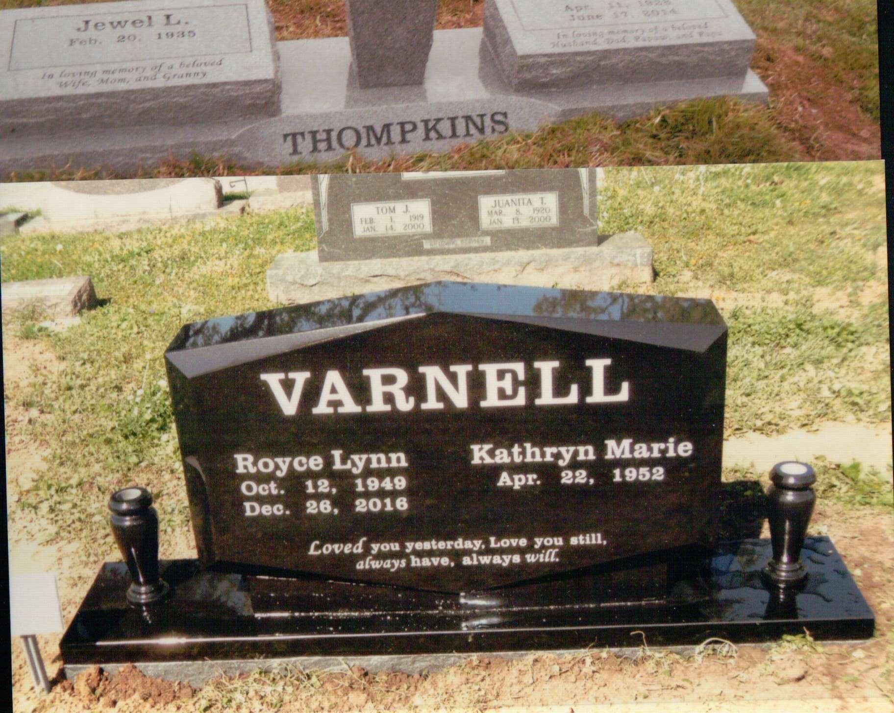 A black granite headstone for the Varnell family, featuring Royce Lynn and Kathryn Marie, set in a cemetery.