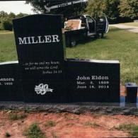 A black granite headstone with the name 