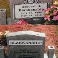 Two gray stone gravestones for Deborah S. Blankenship, decorated with artificial pink flowers in an outdoor cemetery.