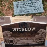 Two cemetery headstones: one featuring a train and 
