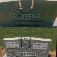 A grey stone headstone for the Melton family, inscribed with the names Terry Wayne and Kimberly L. Melton.