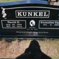 A black granite Kunkel family headstone marking the graves of David O. and Emmaline C. in a cemetery.