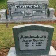 Two granite headstones in a grassy cemetery: the Thompson family monument and the James Randall Blankenburg grave marker.