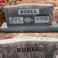 A double-grave granite tombstone inscribed 