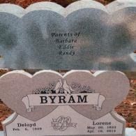 A double heart-shaped granite headstone for Deloyd and Lorene Byram, noting they are parents of Barbara, Eddie, and Randy.