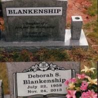 Two gravestones for Deborah S. Blankenship, dated July 22, 1958, to Nov. 24, 2013, with artificial flowers nearby.