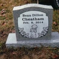 A gray granite headstone inscribed 