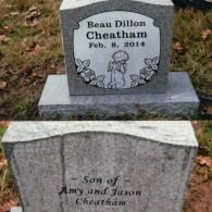 A grave marker for Beau Dillon Cheatham, born February 8, 2014, showing a rose border and a child figure on the front.
