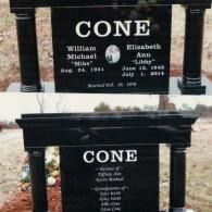 A black granite double-sided headstone for the Cone family, featuring names, dates, and inscriptions in an outdoor setting.