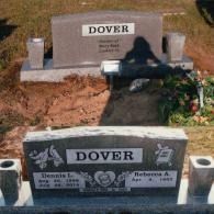 Two grey granite headstones for the Dover family in a cemetery, with the foreground stone showing names and dates.