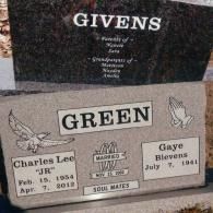 A light-colored memorial headstone inscribed with 