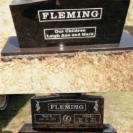 A two-part image showing both sides of a black polished stone headstone marked 