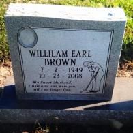 A gray granite tombstone for Willilam Earl Brown (1949-2008), featuring an engraving of a person golfing.