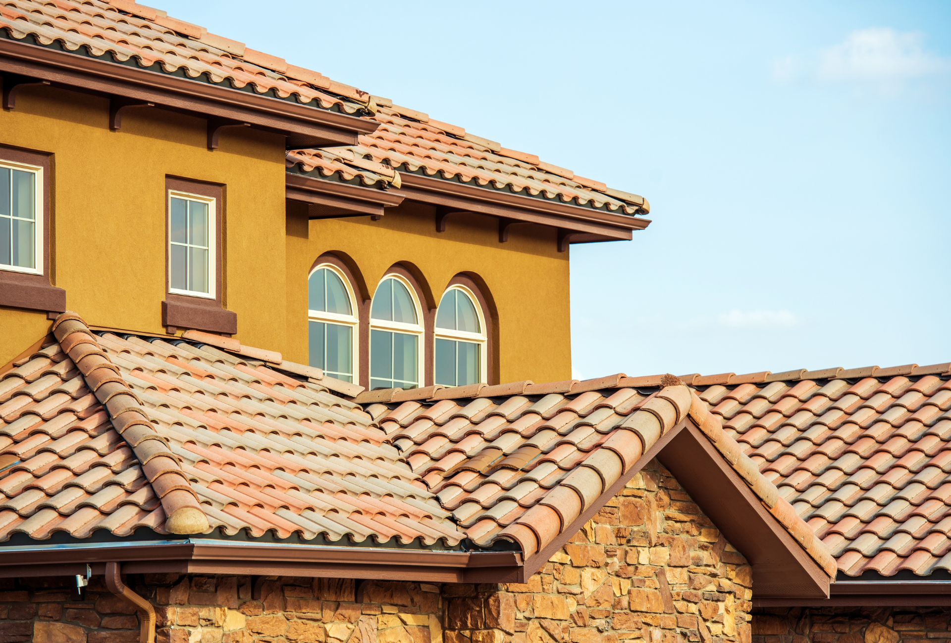 A large house with a tiled roof and arched windows.