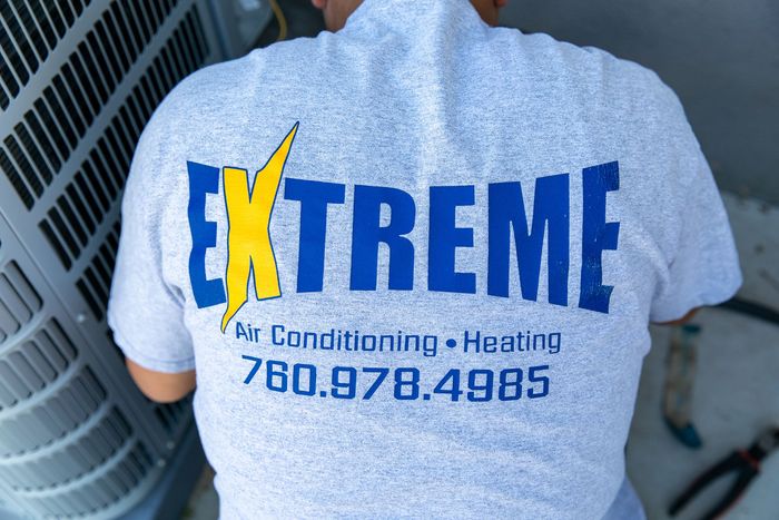 A man wearing a shirt that says extreme on it