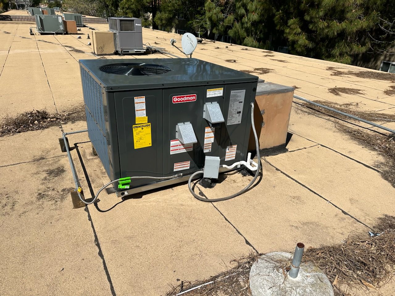 An air conditioner is sitting on the roof of a building