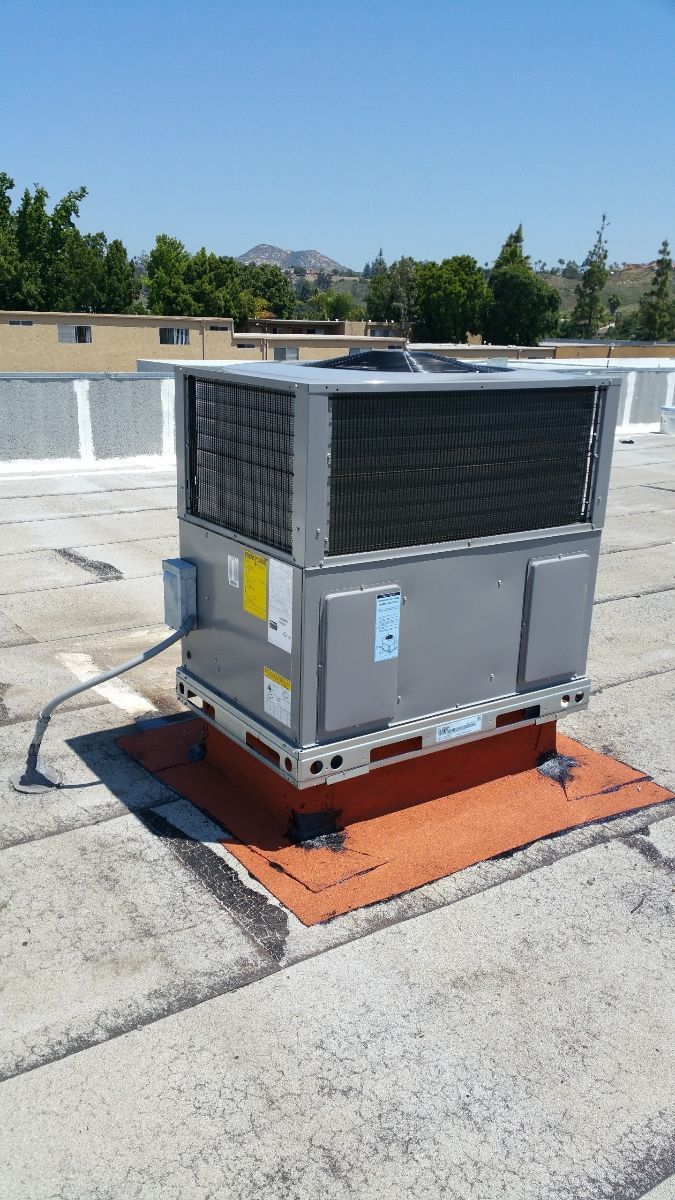 An air conditioner is sitting on top of a roof