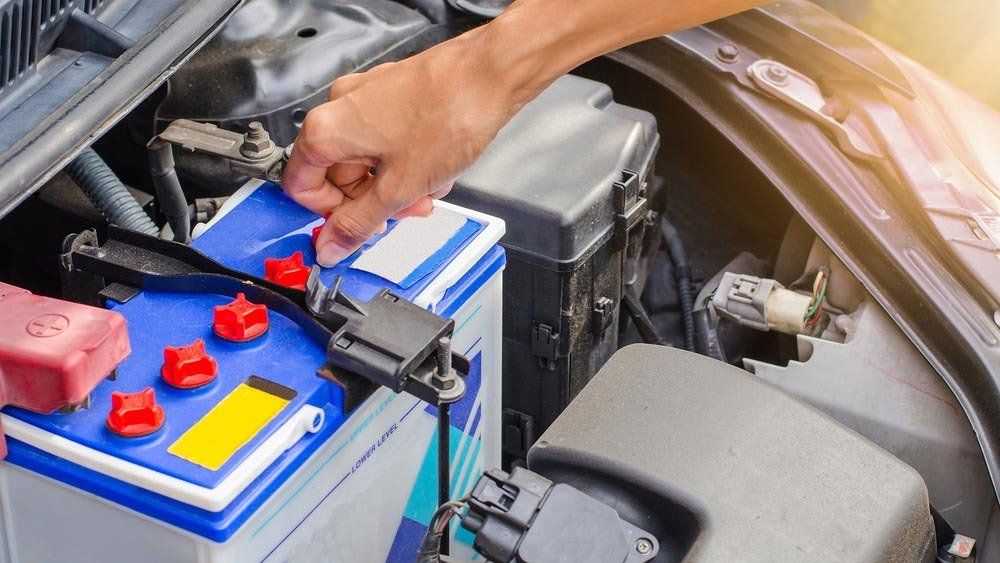 Mechanic Closing the Battery Cap — Automotive Batteries in Boonah, QLD