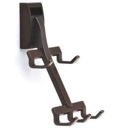 A brown hook with three hooks attached to it on a white background.