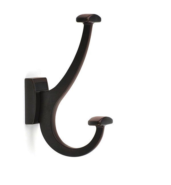 A brown hook on a white wall with a white background
