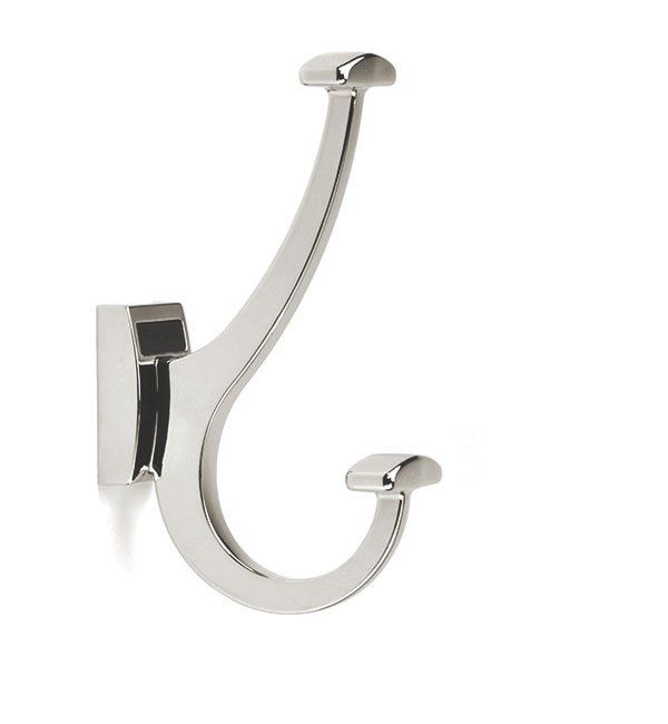 A chrome coat hook is hanging on a white wall.