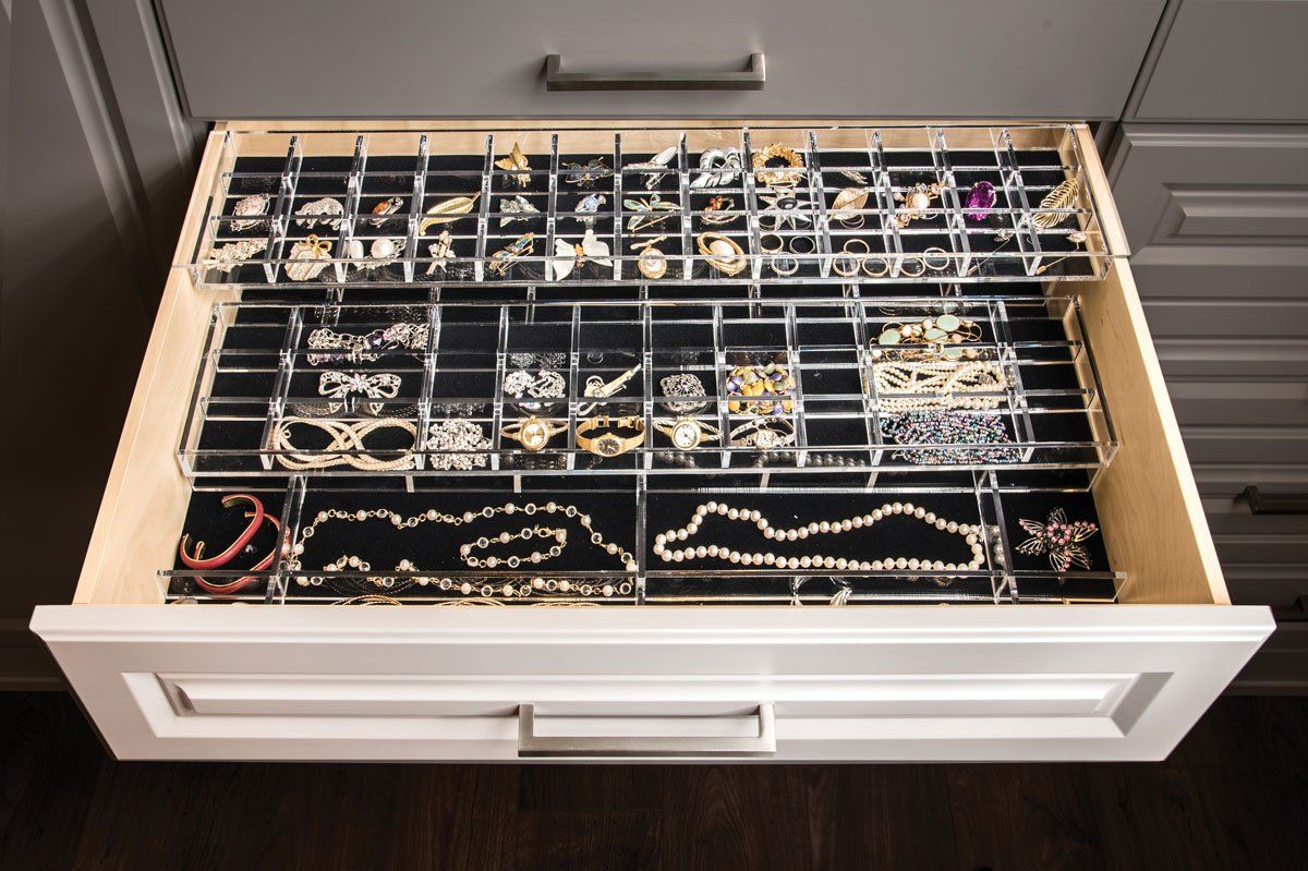 A drawer filled with lots of jewelry including necklaces and bracelets.