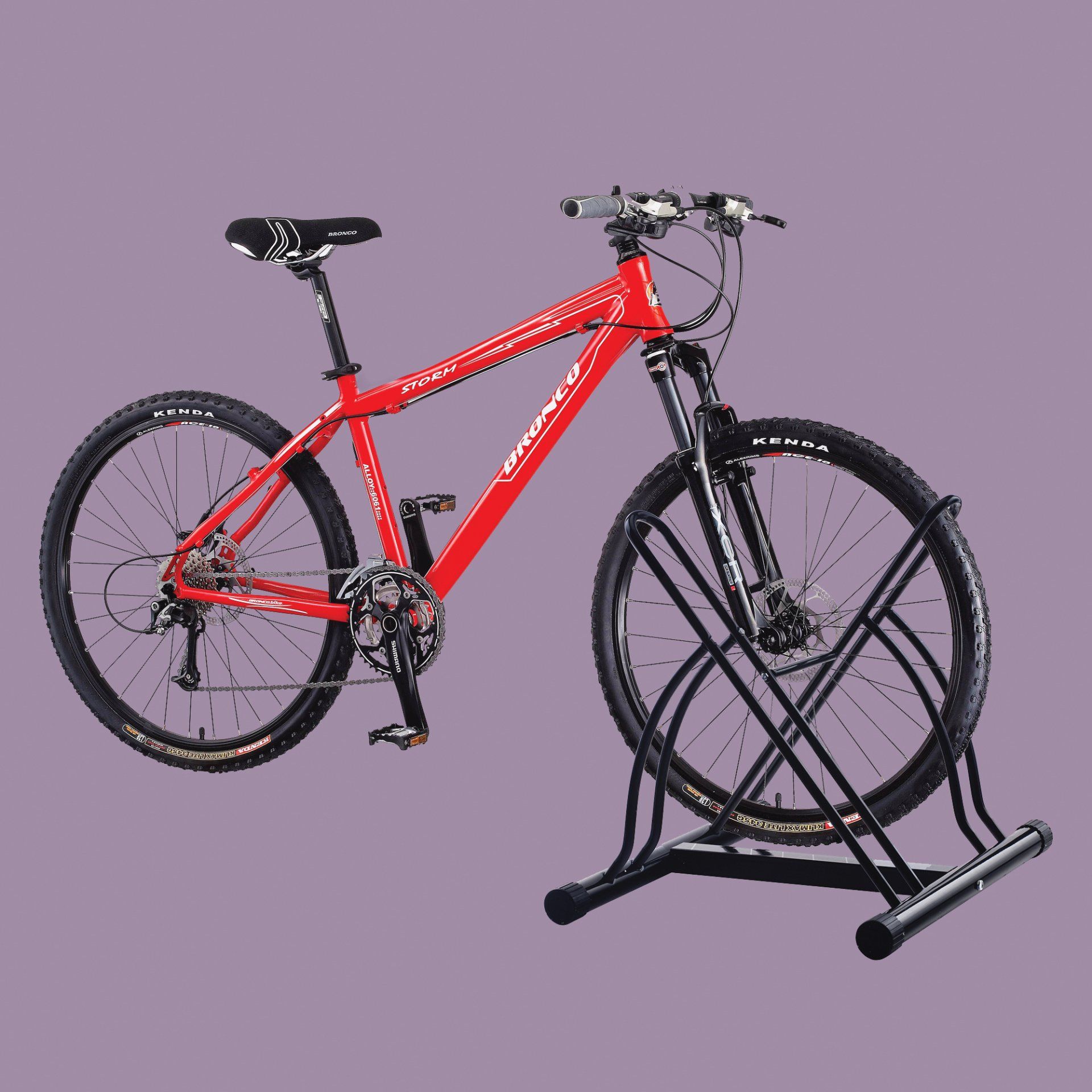 A red bicycle is parked on a black stand