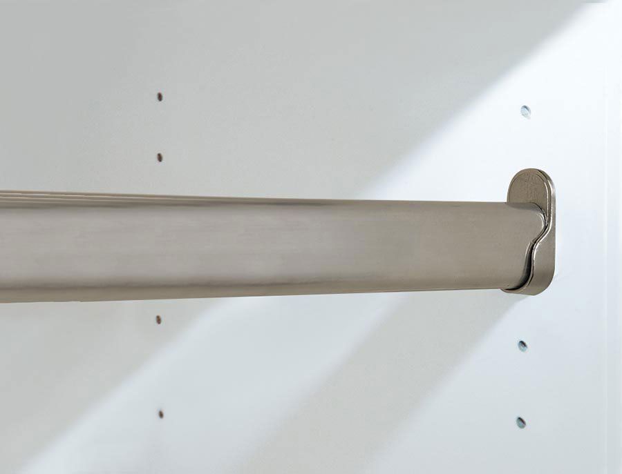 A stainless steel clothes rack is hanging on a white wall.