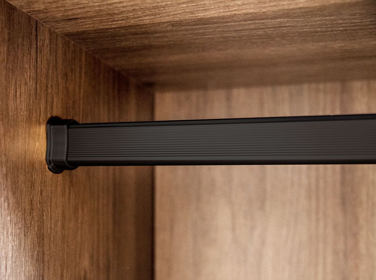 A close up of a black clothes rack in a wooden wardrobe.