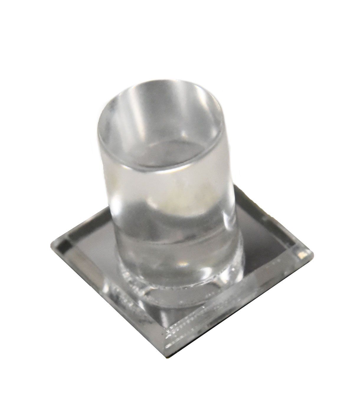 A clear glass sitting on top of a square tray