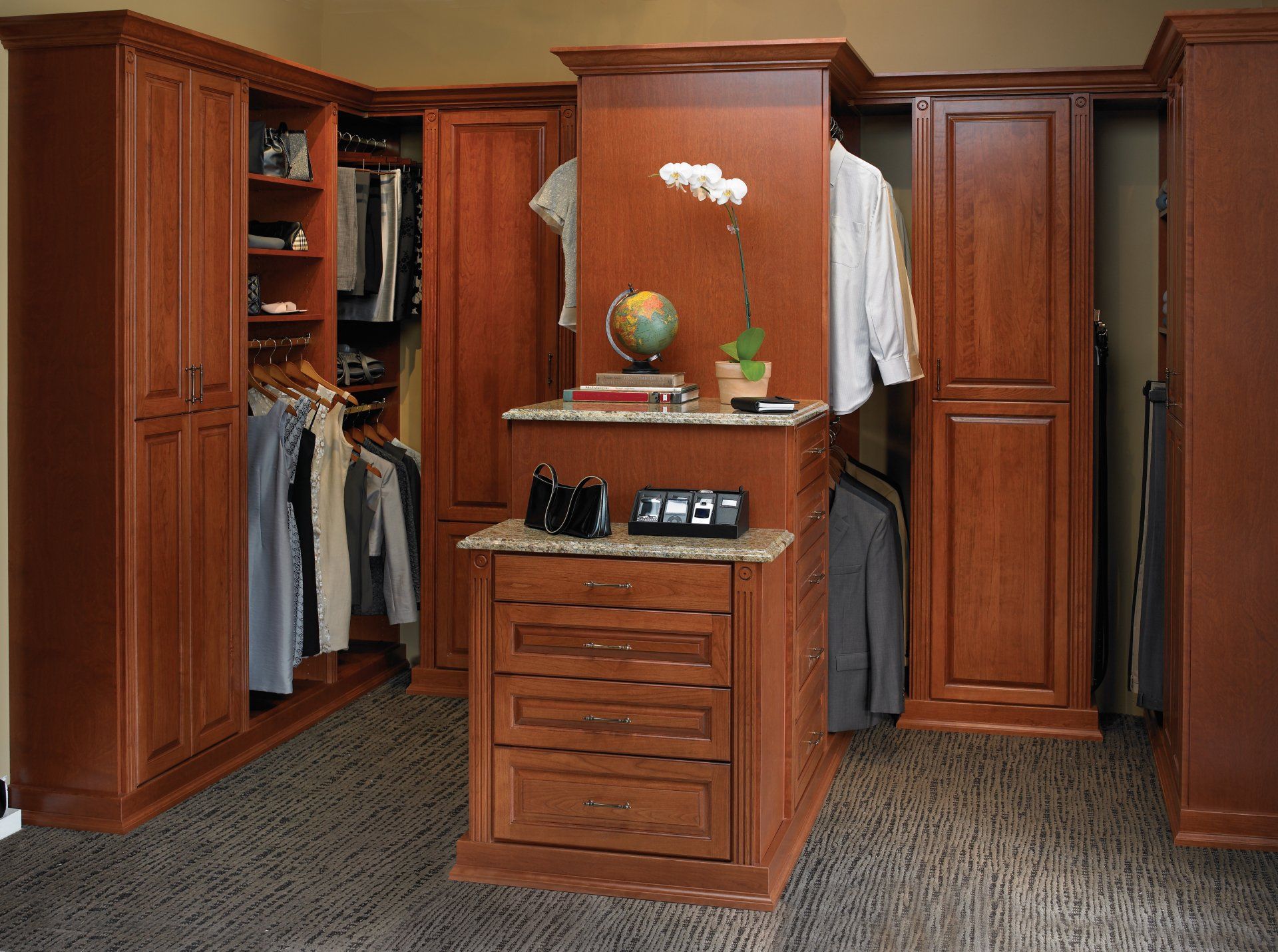 A walk in closet with wooden cabinets and drawers