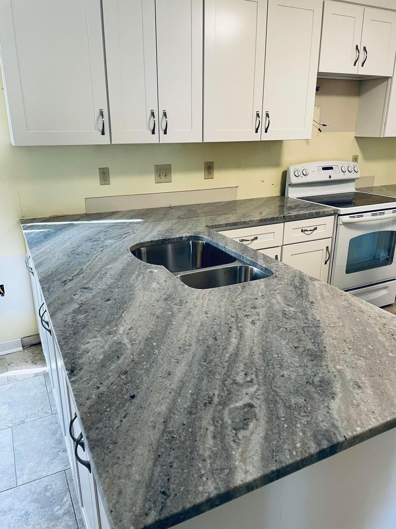 a kitchen with a granite counter top and a sink