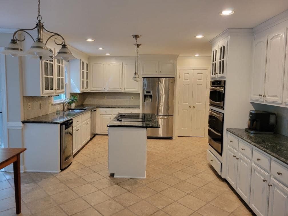 a kitchen with white cabinets and stainless steel appliances