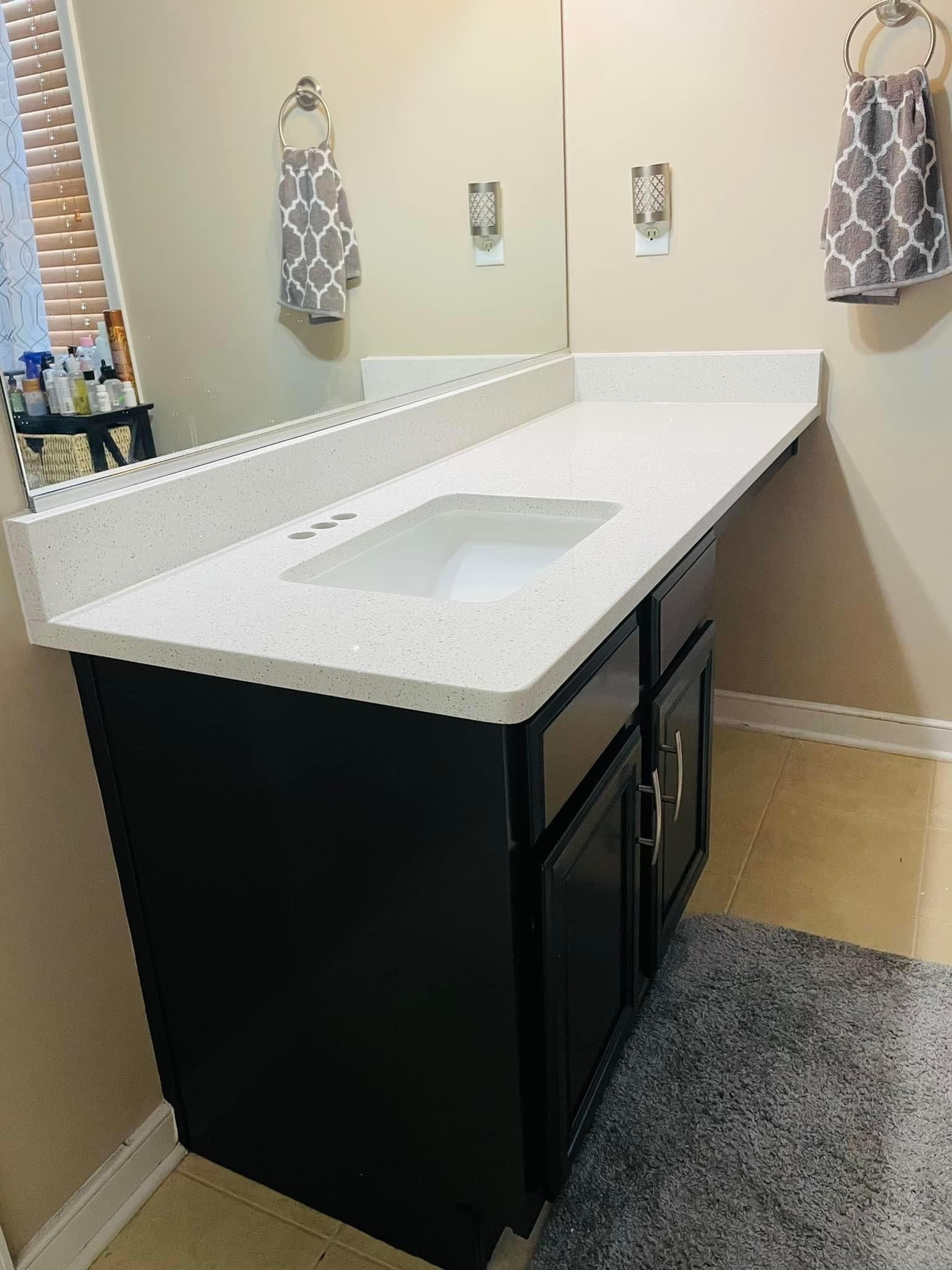 A bathroom vanity with a sink and a mirror.