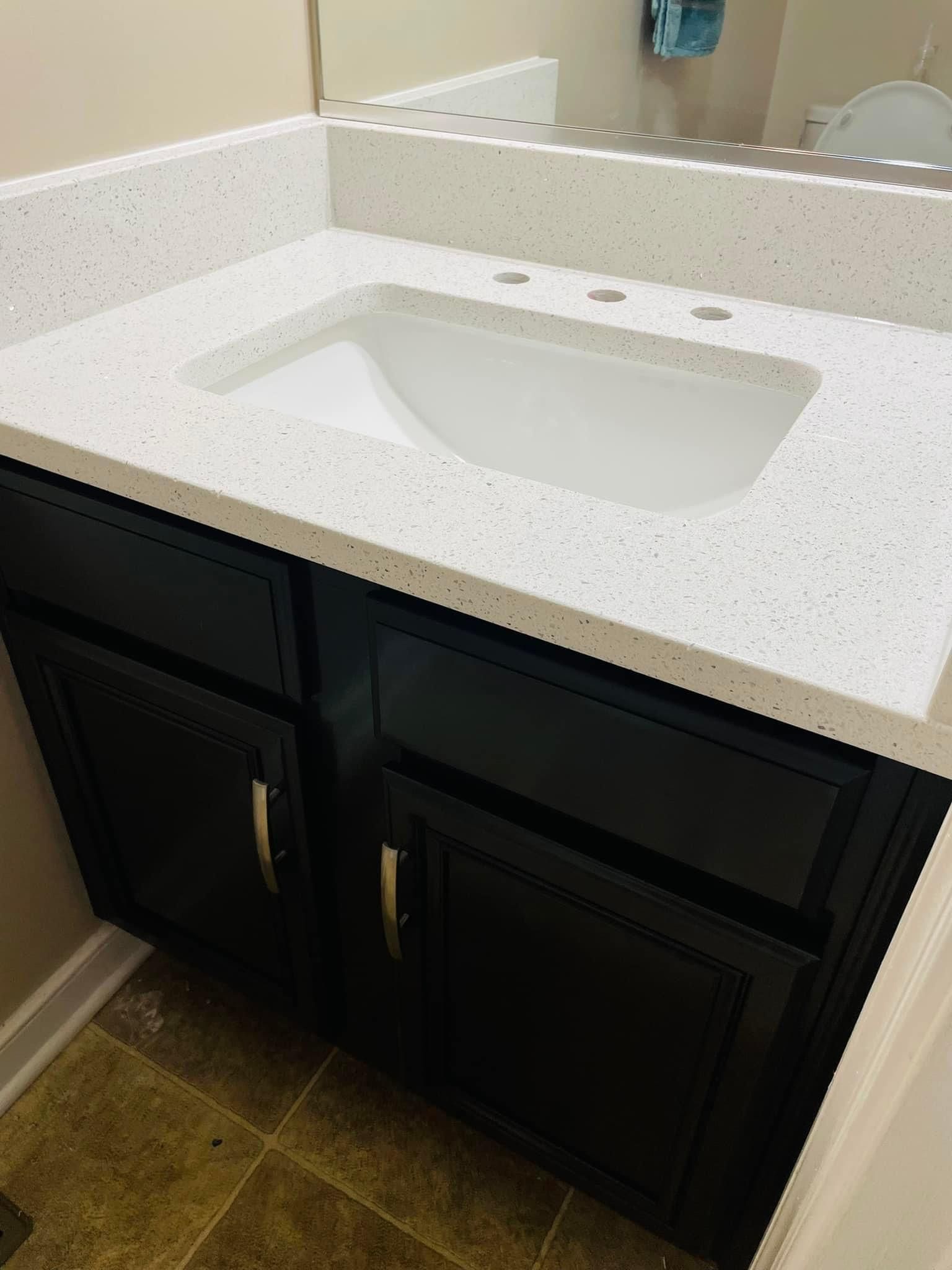 A bathroom vanity with a sink and a mirror.