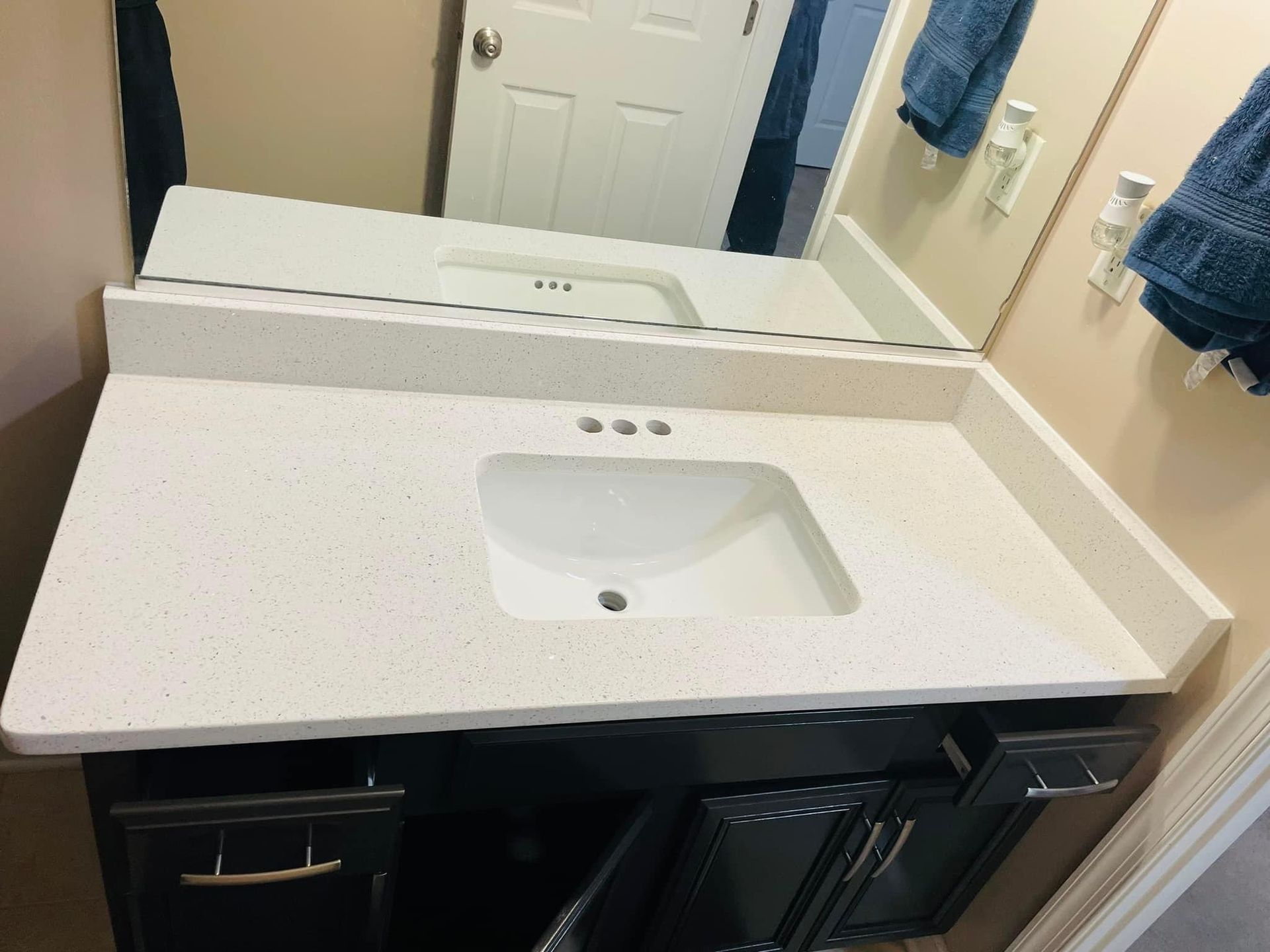 A bathroom vanity with a sink and a mirror