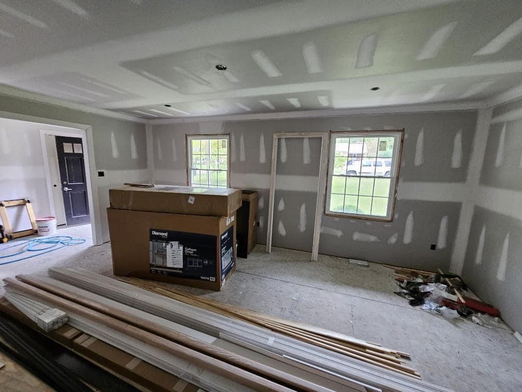 A room that is being remodeled with drywall and a box on the floor.