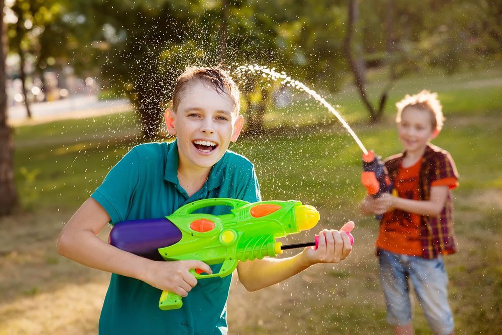 Kids playing water using water gun